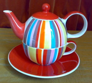 Teapot nesting on cup and saucer.