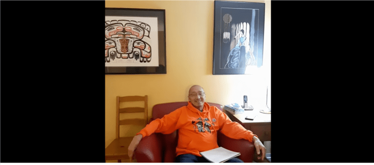 Still from video of Lyle Jacob John sitting in his apartment at the Aboriginal Patient Lodge, Vancouver, B.C. November 2022